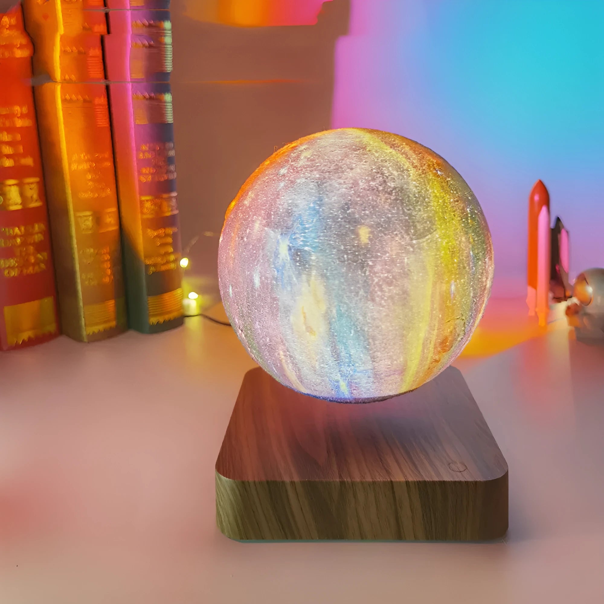 Levitating galaxy moon lamp floating above walnut colour base with starry light pattern