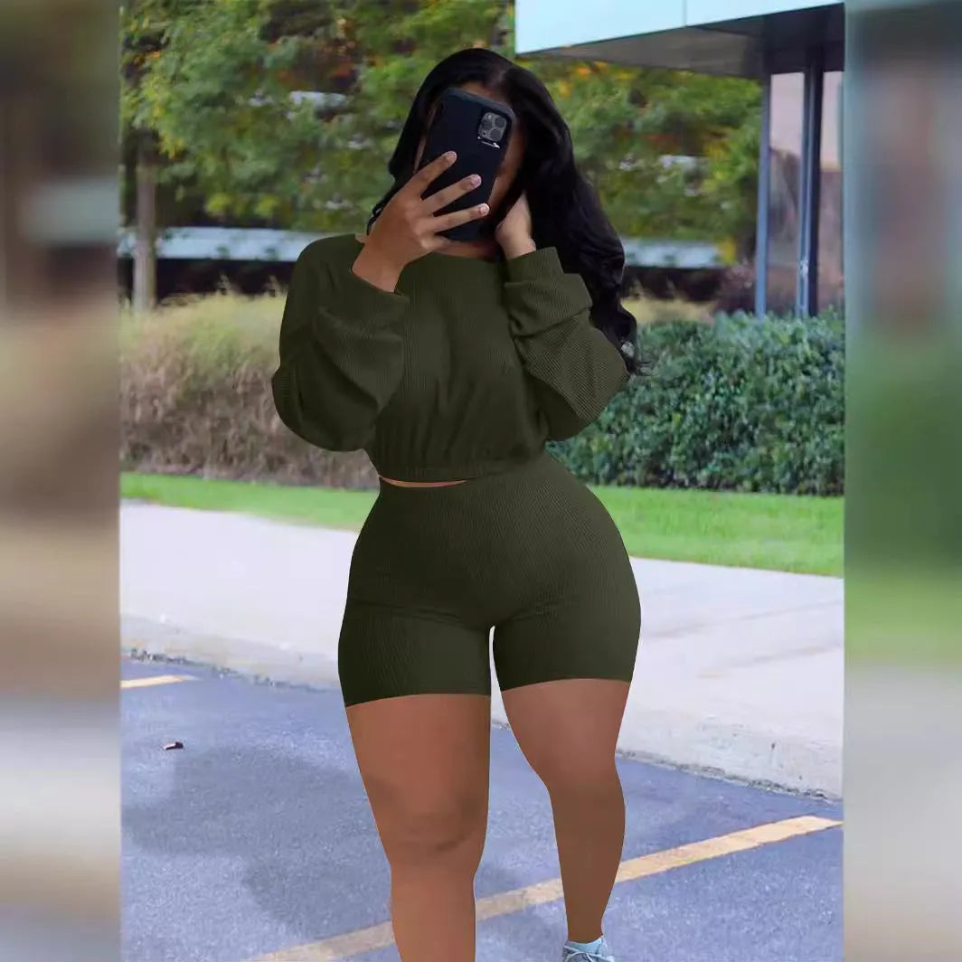 Women's off-the-shoulder long sleeve top and shorts two-piece set in a solid colour.