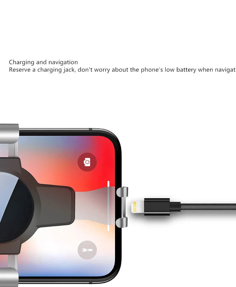 Black S4 gravity mobile phone bracket clipped onto a car air conditioning vent, holding a smartphone.