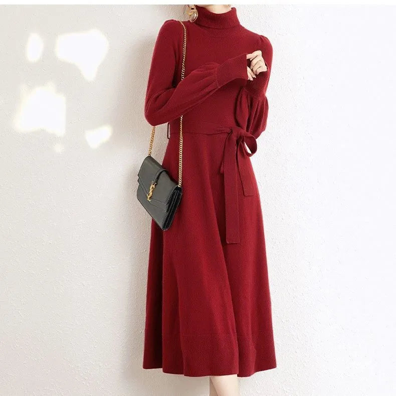 Rose red knitted turtleneck pullover dress with long sleeves and a loose, mid-length skirt with an elasticated waist.