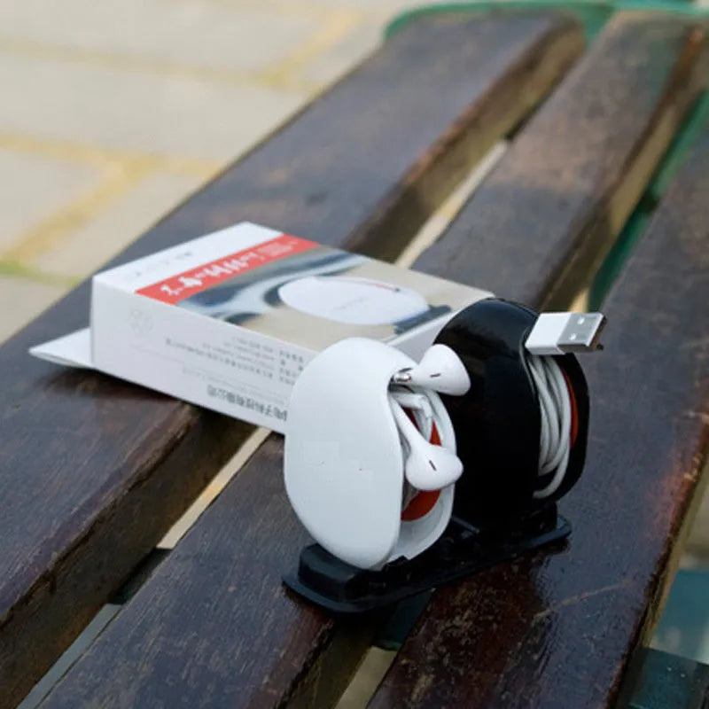 Automatic earphone cable winder with telescopic push mechanism showing compact design