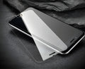 Tempered glass screen protector with 9H hardness for smartphone display.