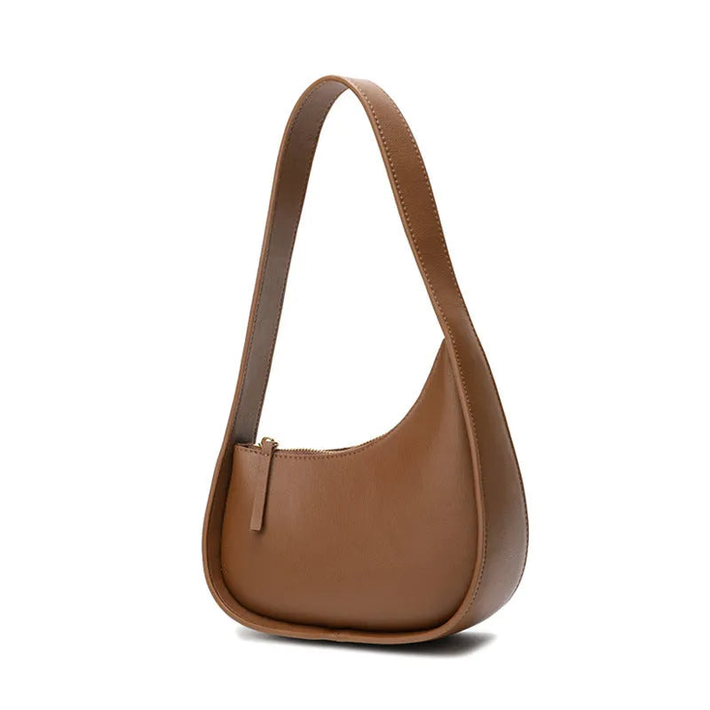 Small genuine cowhide leather half moon handbag with a wide shoulder strap.