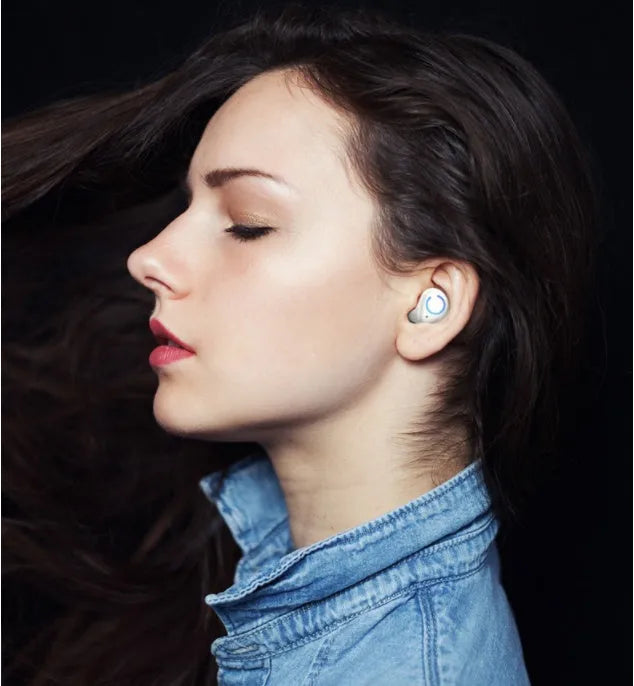Black and white M18 true wireless in-ear Bluetooth headset with charging case.