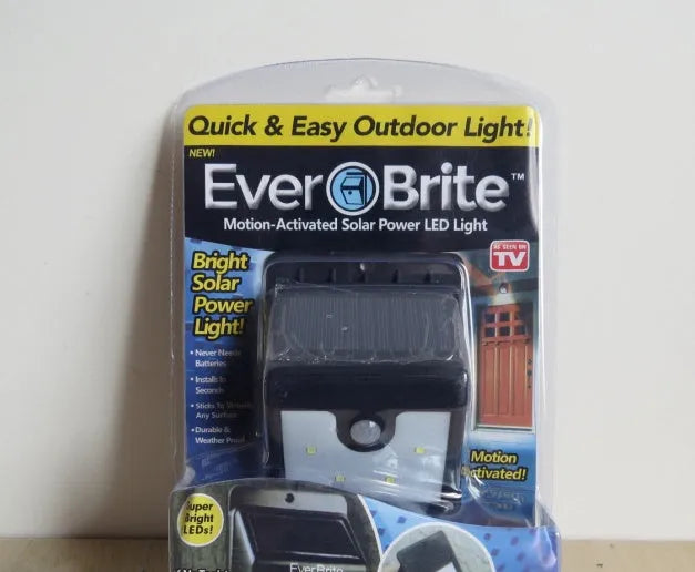 Set of four white solar-powered outdoor security lights with stainless steel mounting brackets