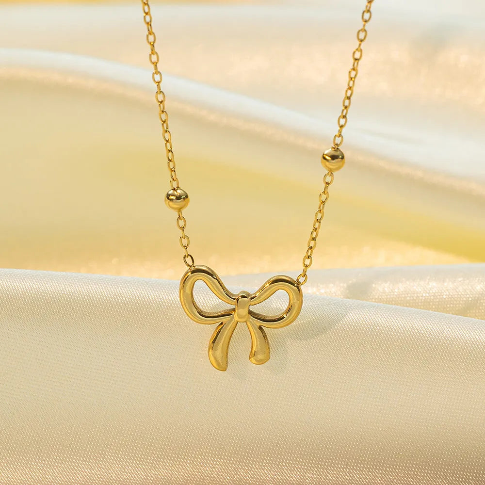 Gold bow necklace for women with cross chain design and adjustable length