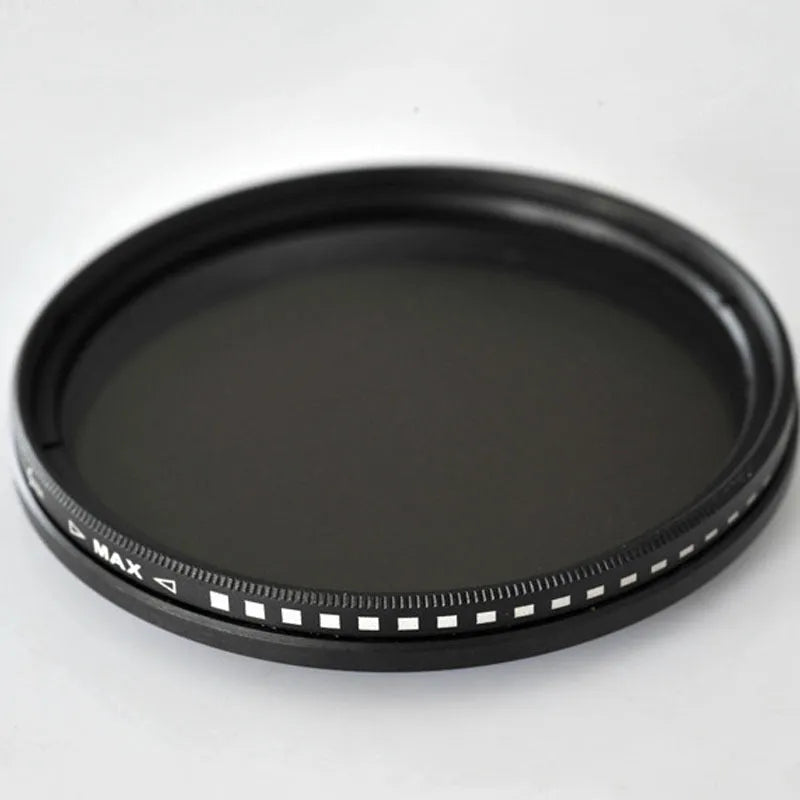 Set of four neutral density camera lens filters with multiple thread size adapters
