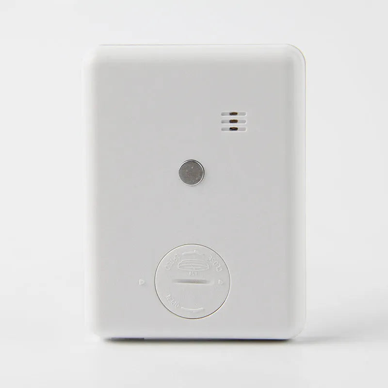 Black and white kitchen timer with magnet back for refrigerator mounting.