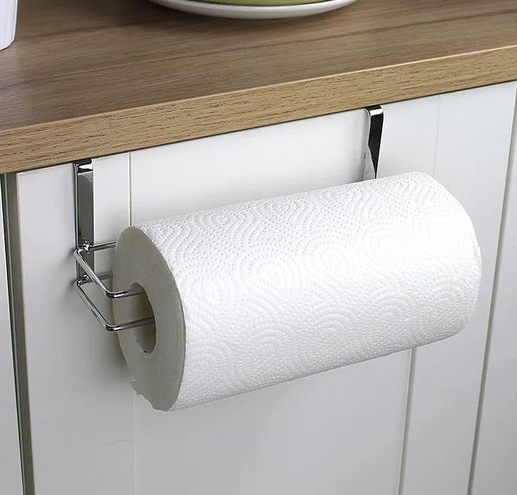 Silver stainless steel paper towel rack hanging over cabinet door for kitchen storage