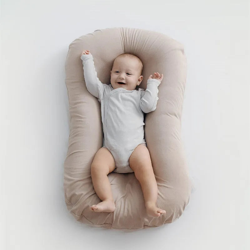 Beige portable cotton baby nest bed crib for newborns, measuring 75 cm by 45 cm.