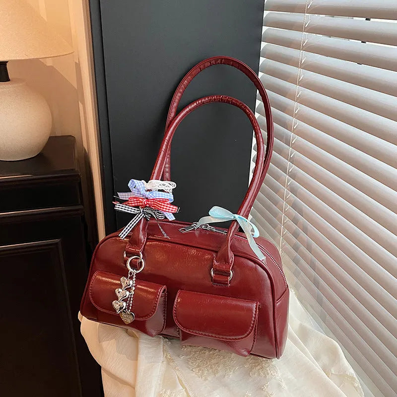 Retro brown PU women's pillow handbag with a flap closure and double shoulder strap.
