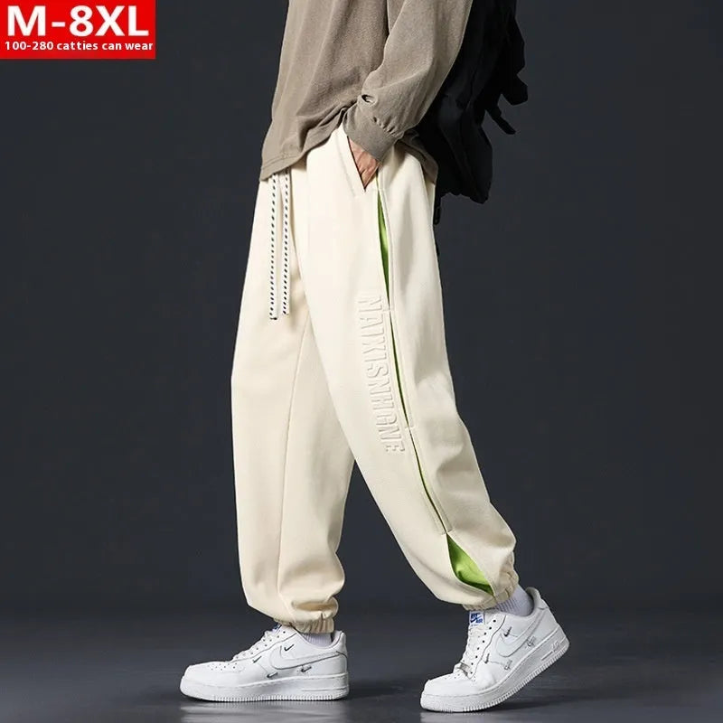 Men's grey green cotton casual trousers with white collage stitching detail and an elasticated ankle band.