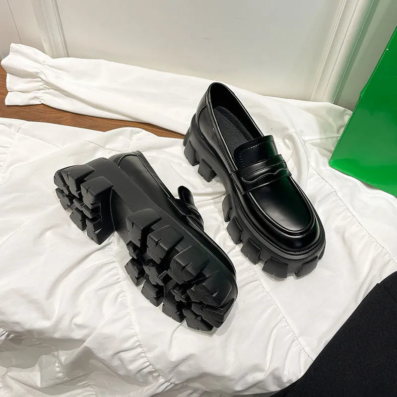 A pair of British style wide fit loafers with a shallow opening, shown in a choice of matte or glossy patent leather.