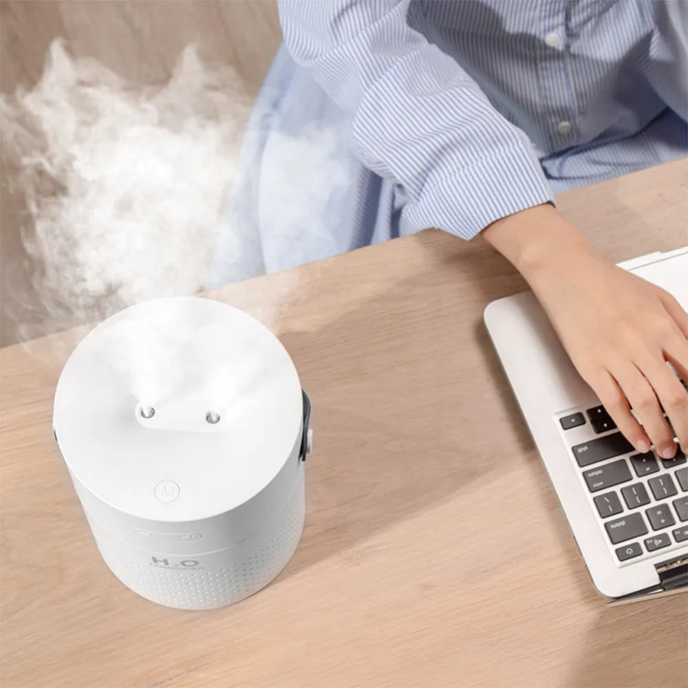 Slim white USB rechargeable humidifier with water tank and colour LED lighting on wooden bedside table