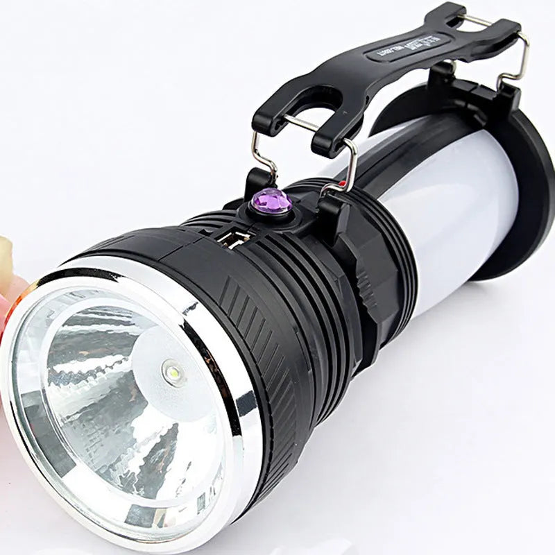 Black solar-powered rechargeable LED torch with USB charging port.
