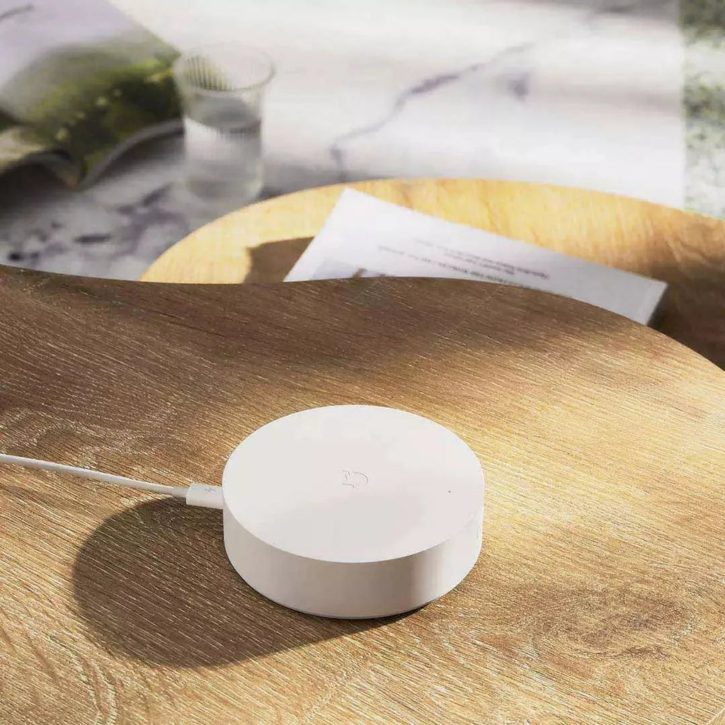 White circular Xiaomijia smart home gateway with UK plug for wireless control of smart home devices