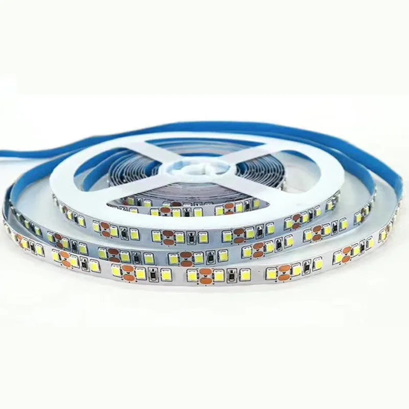 Flexible white LED strip light coiled on a reel, showing close-up of 2835 and 5050 LEDs for shelf lighting.