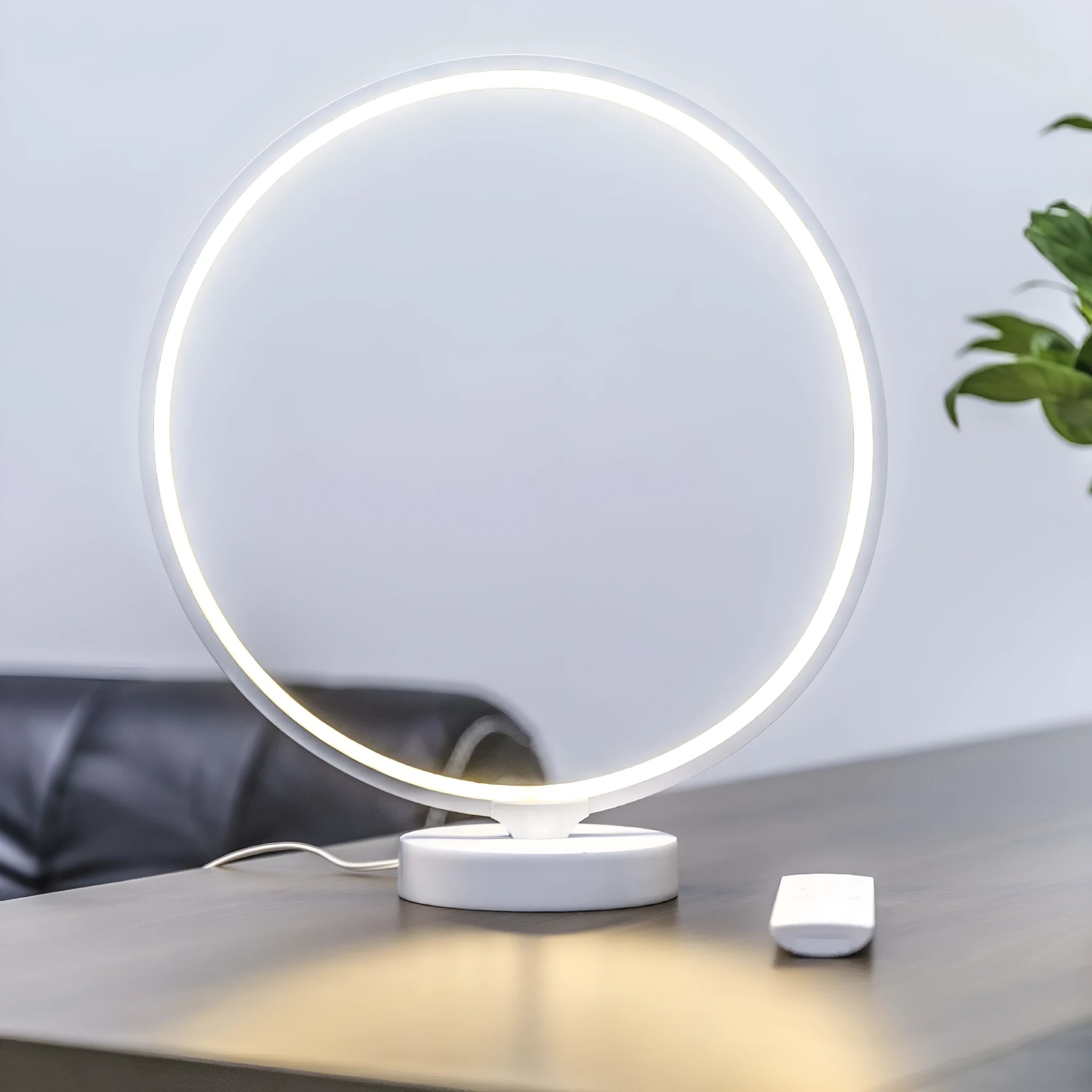 White Full Moon Table Lamp with remote control on a wooden surface