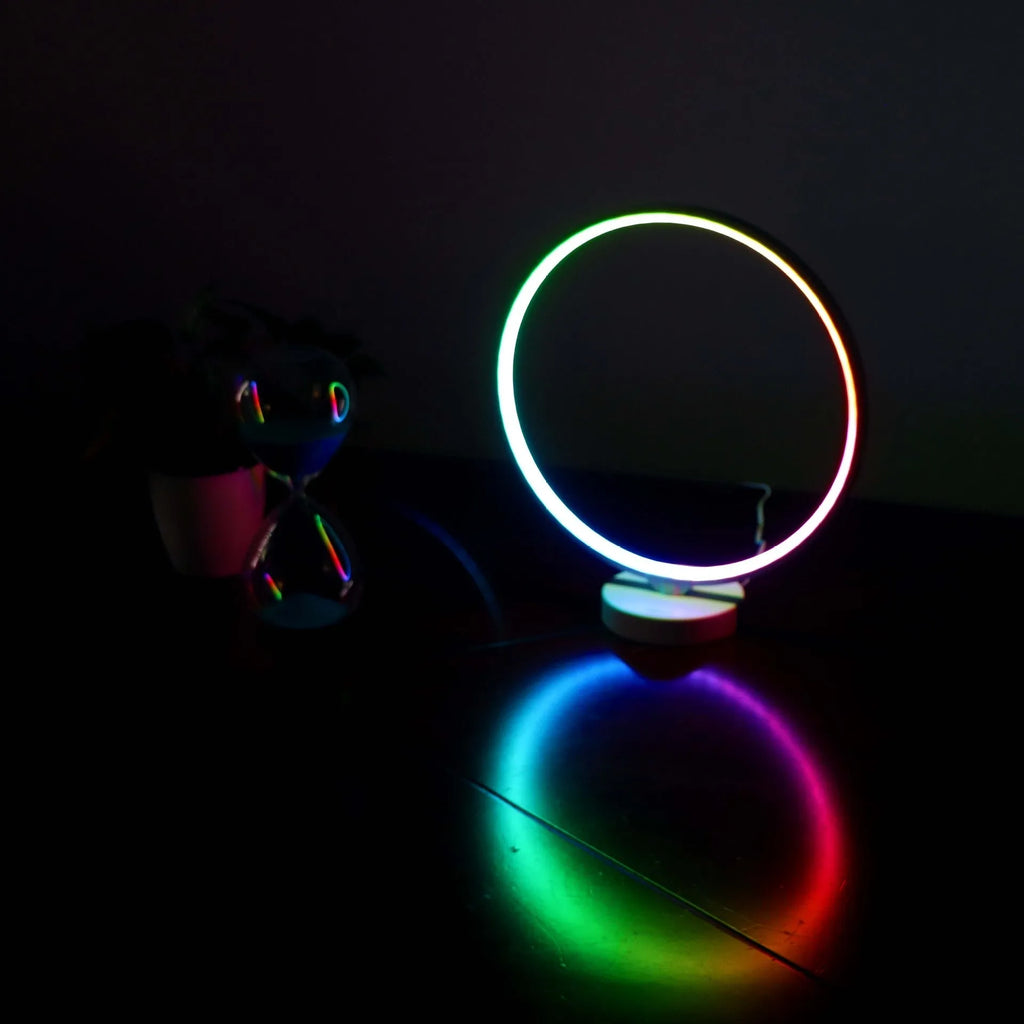White Full Moon Table Lamp with remote control on a wooden surface