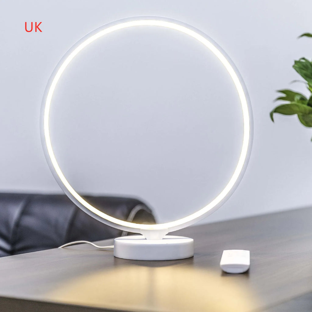 White Full Moon Table Lamp with remote control on a wooden surface