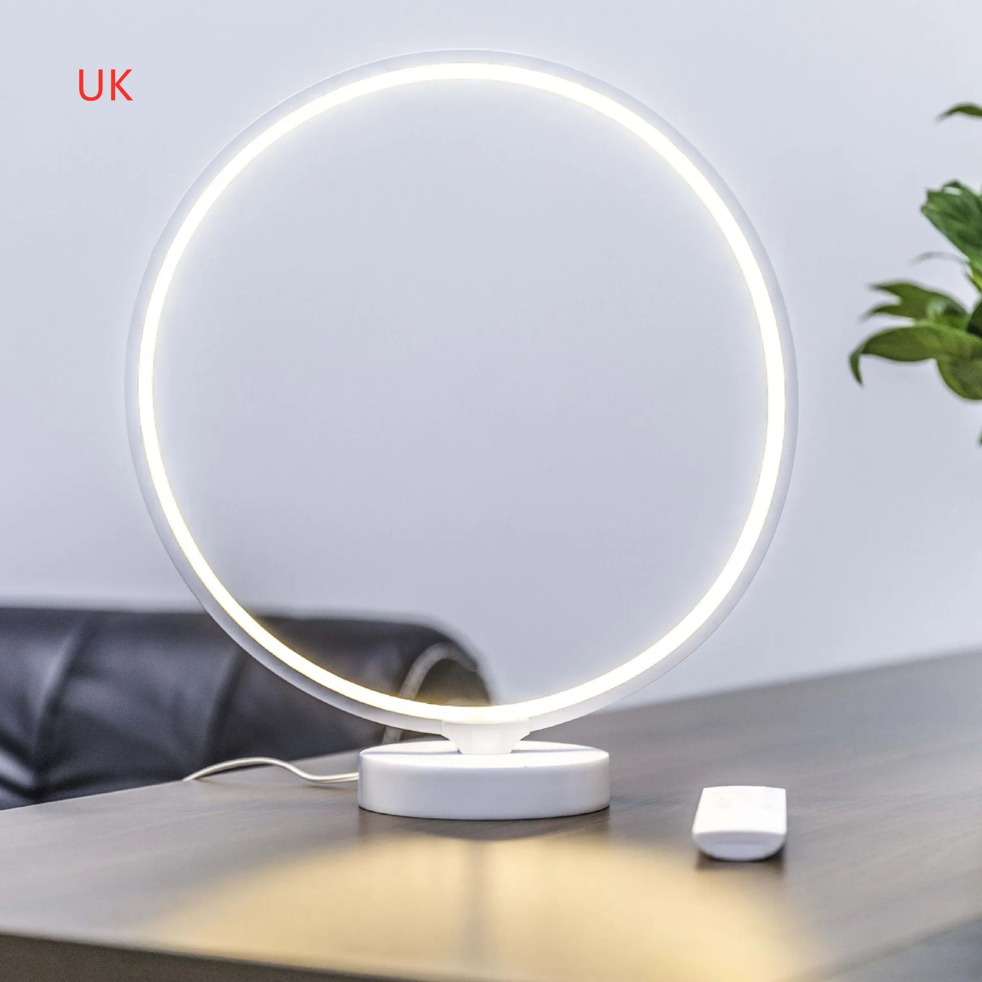 White Full Moon Table Lamp with remote control on a wooden surface