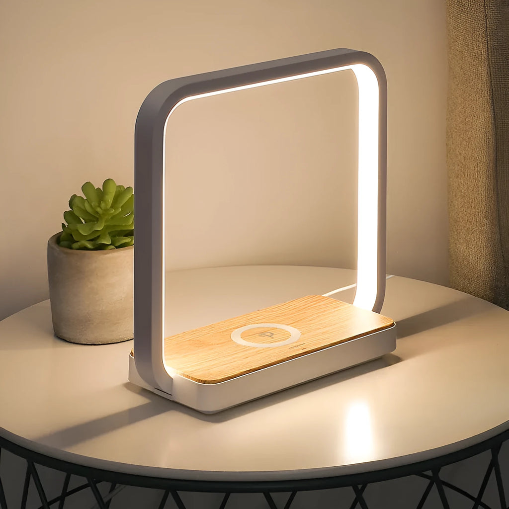 White modern smart bedside lamp with touch sensor and voice control on a wooden table.