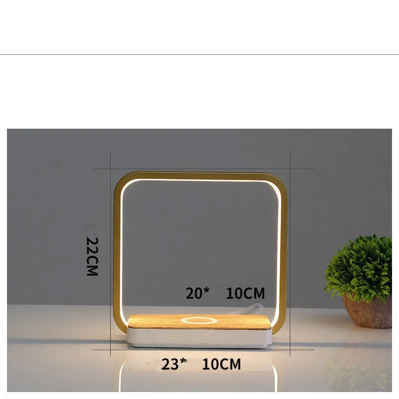 White modern smart bedside lamp with touch sensor and voice control on a wooden table.