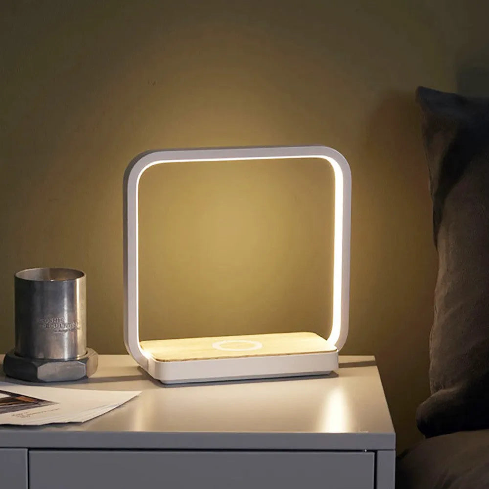 White modern smart bedside lamp with touch sensor and voice control on a wooden table.