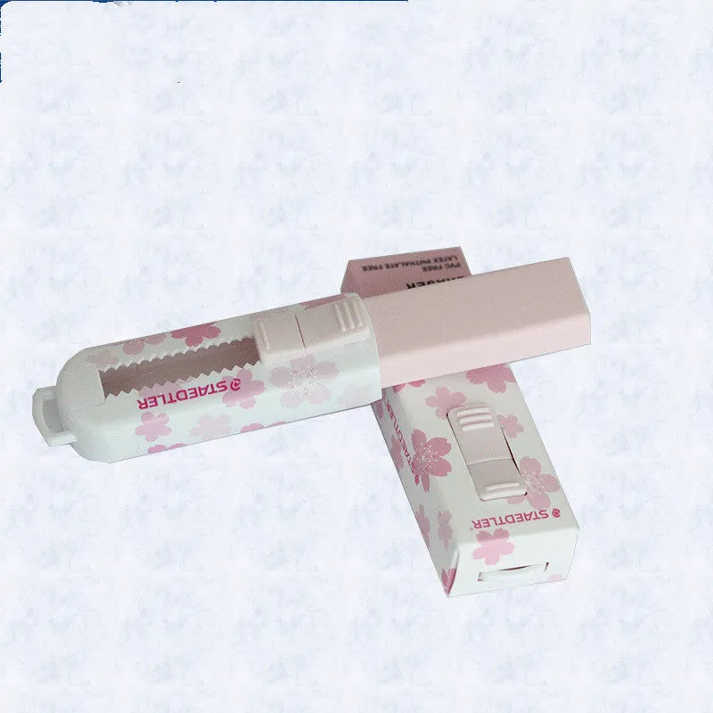 Pink student-use whiteboard cleaner with replaceable rubber core and push-pull mechanism