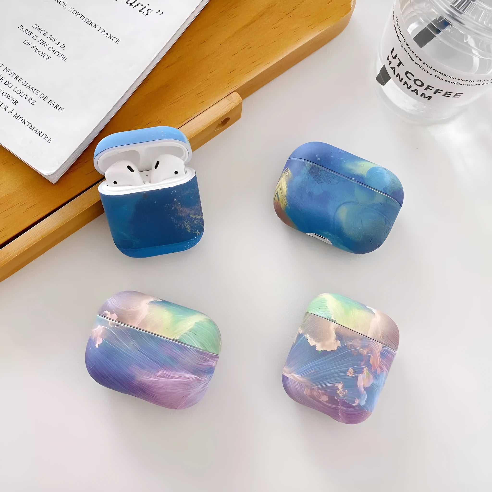 Hard plastic protective sleeve for Apple AirPods case in pink watercolour design.