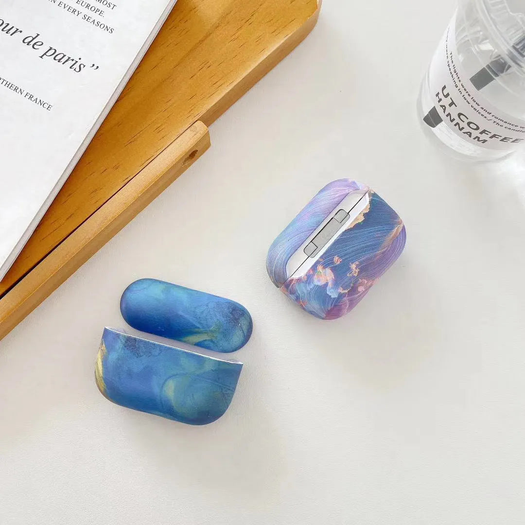 Hard plastic protective sleeve for Apple AirPods case in pink watercolour design.