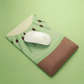 Soft silicone and cloth wrist support mouse pad with cute printed design, showing non-slip base.