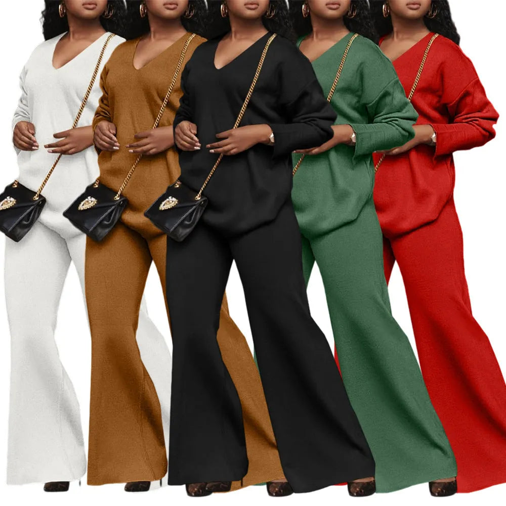 Women's brown suede two-piece suit with long sleeves and trousers on a hanger