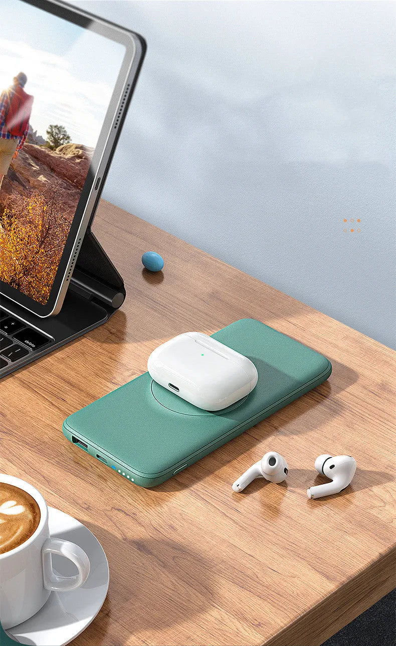 Mint green MagSafe magnetic wireless power bank with back clip, showing compact size next to an iPhone for scale.
