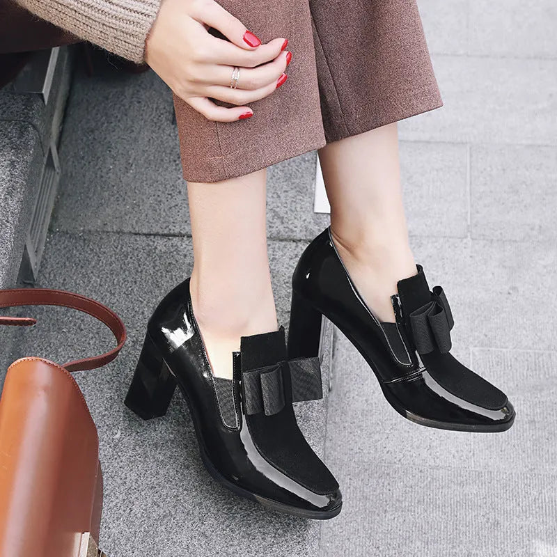 Women's black leather high heels with a thick square heel over 8cm and a square toe.