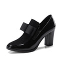 Women's black leather high heels with a thick square heel over 8cm and a square toe.