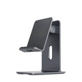 Alloy mobile phone and tablet holder stand in dark space grey and silver on a desktop.