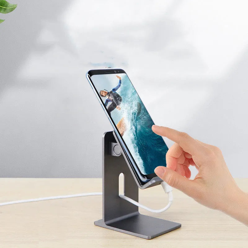 Alloy mobile phone and tablet holder stand in dark space grey and silver on a desktop.