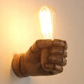 Resin creative fist wall lamp in black, white, or wood grain finish for bar or corridor decoration.