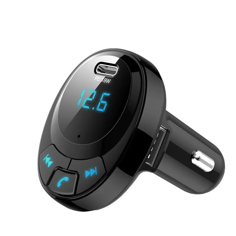 Black car Bluetooth MP3 charger with digital display and dual USB ports plugged into a car cigarette lighter.
