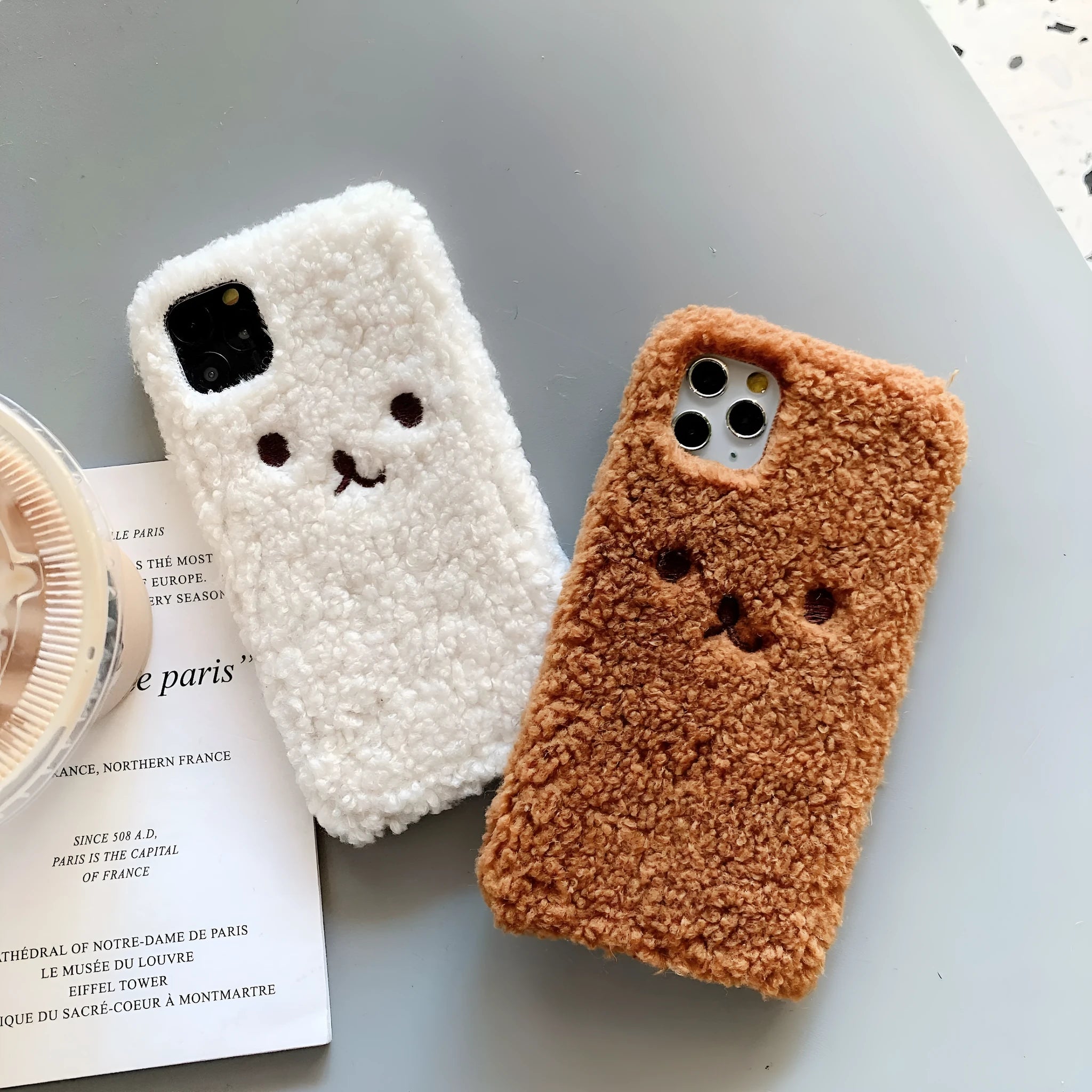Brown embroidered plush cartoon bear face on a soft TPU iPhone phone case.