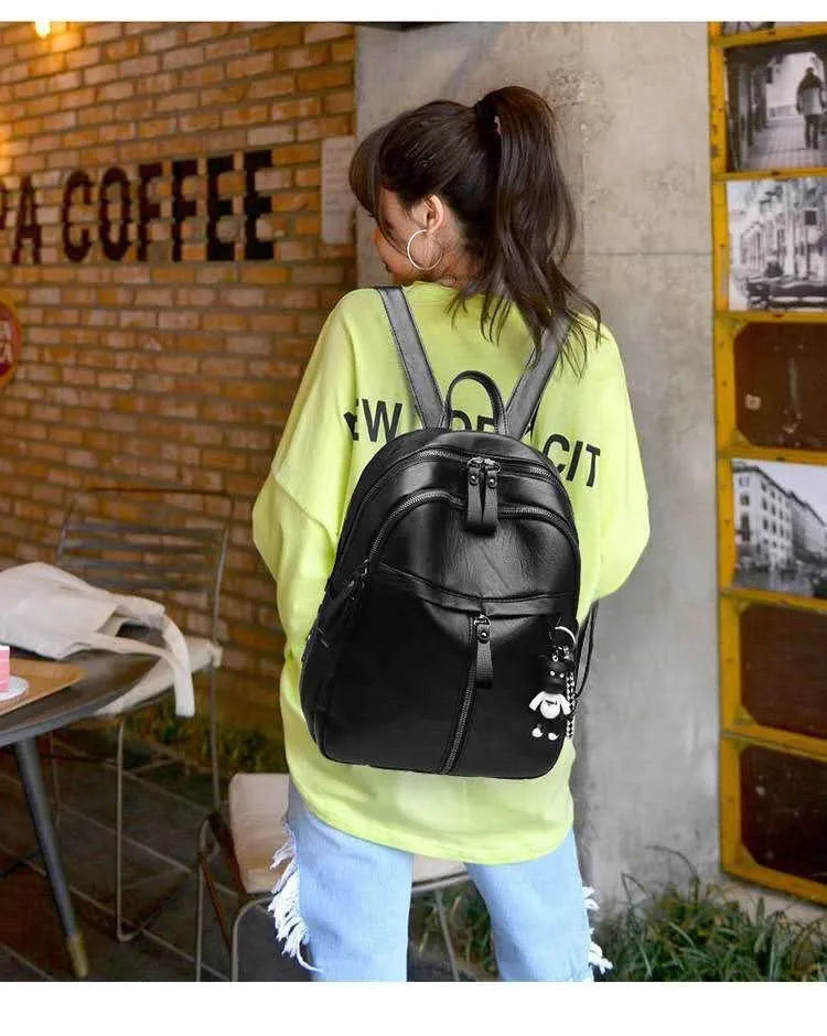 Black soft PU leather medium backpack with two shoulder straps, shown closed.