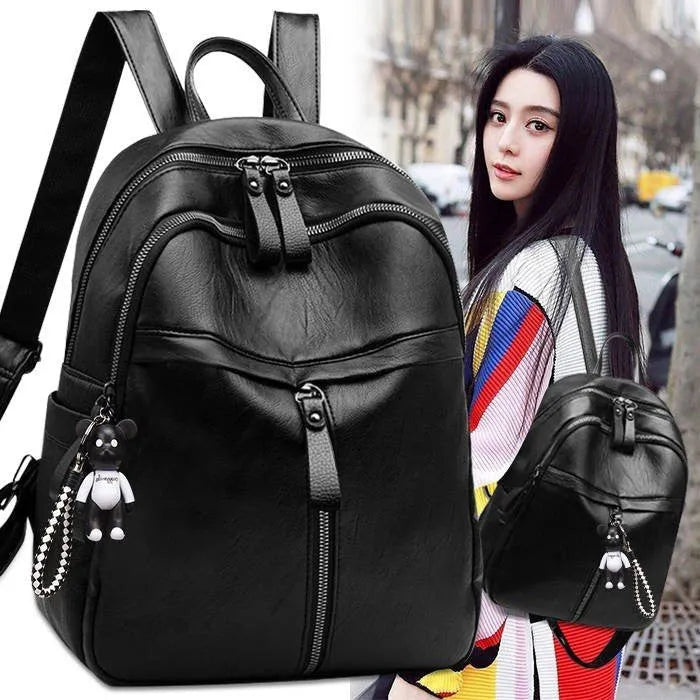 Black soft PU leather medium backpack with two shoulder straps, shown closed.