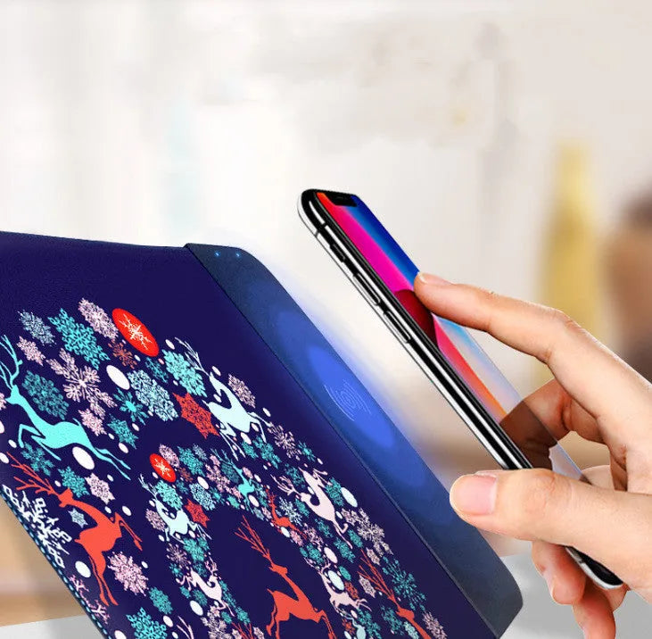 Wireless charging mouse pad with RGB lighting and cartoon design on black desk