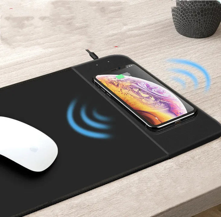 Wireless charging mouse pad with RGB lighting and cartoon design on black desk