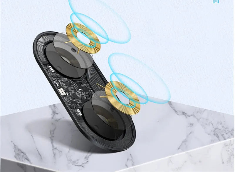 Baseus minimalist two-in-one wireless charger and power bank in black, on a desk charging a phone.