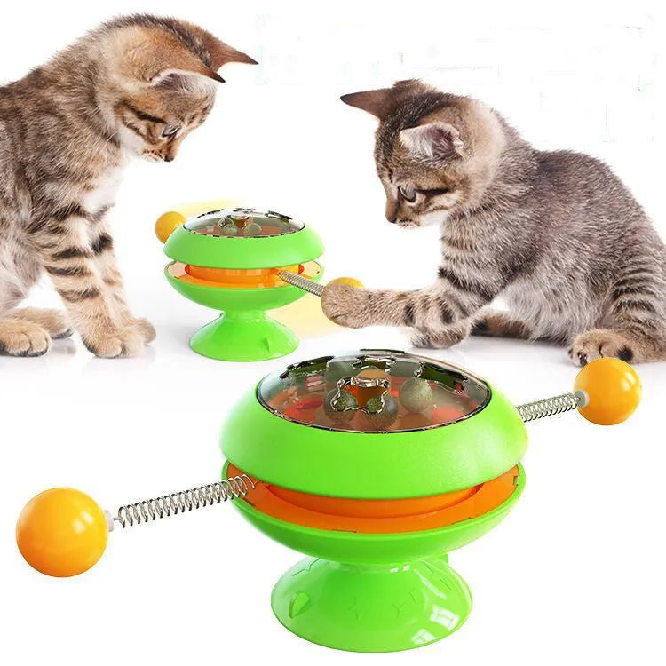 Rotatable cat toy with catnip balls in transparent compartment and large suction cup base