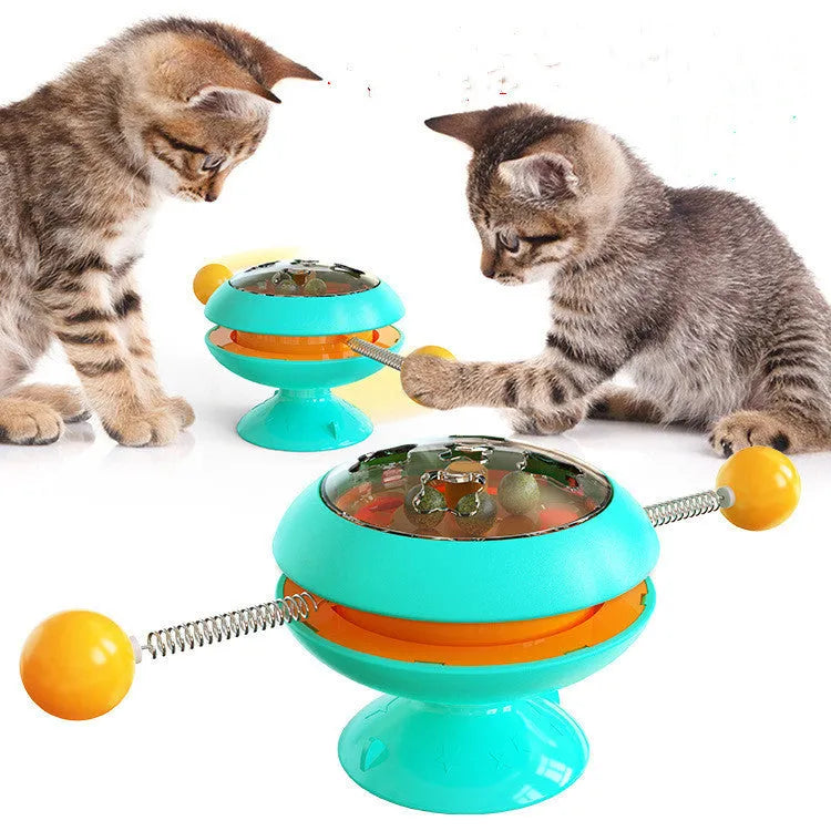 Rotatable cat toy with catnip balls in transparent compartment and large suction cup base