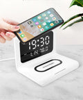 White wireless charger alarm clock displaying time, calendar, temperature and humidity readings