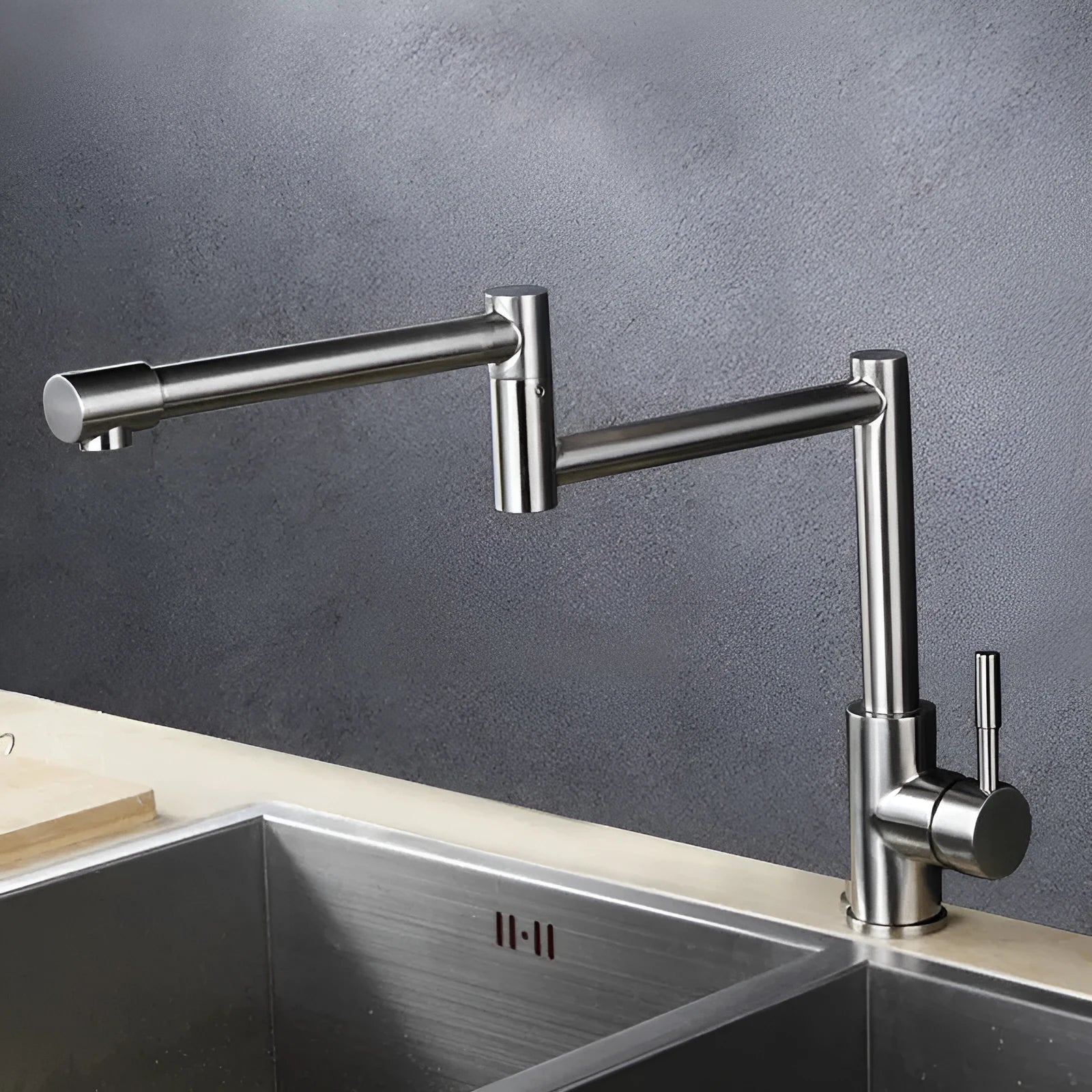 Silver stainless steel kitchen mixer tap with dual lift-up controls and rotating spout